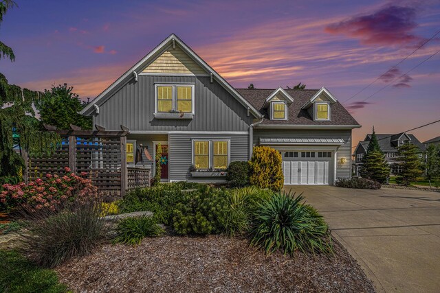 7251 E Beach Dr, South Haven, MI 49090 - view of front of home with a garage, concrete driveway, and board and batten siding