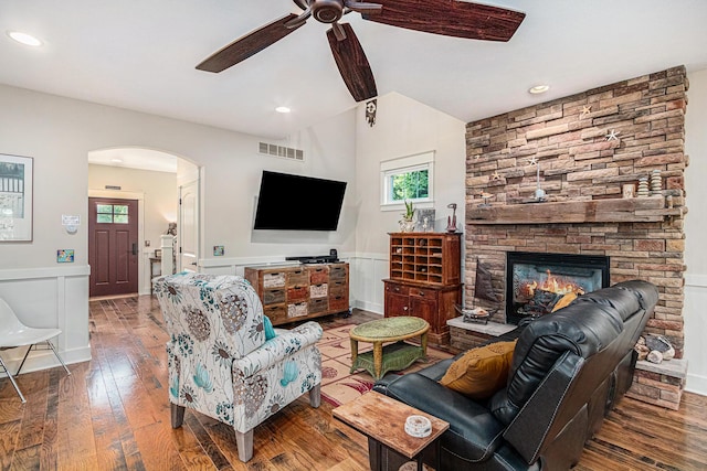 7251 E Beach Dr, South Haven, MI 49090 - living room with arched walkways, a ceiling fan, hardwood / wood-style flooring, wainscoting, and a fireplace