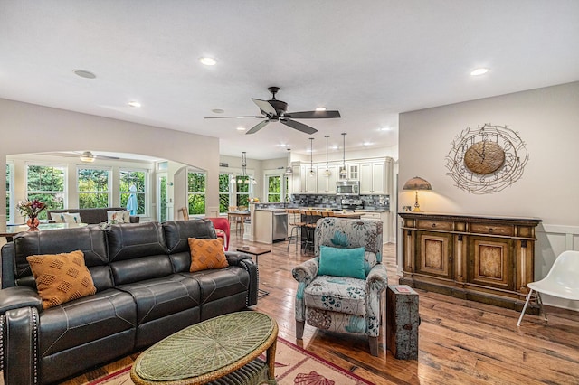 7251 E Beach Dr, South Haven, MI 49090 - living room featuring a ceiling fan, arched walkways, light wood-type flooring, and recessed lighting