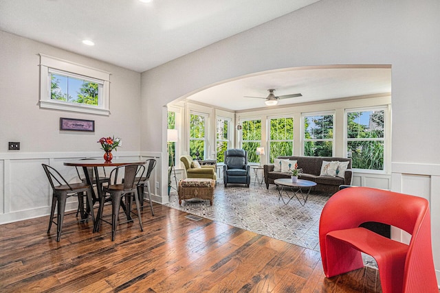 7251 E Beach Dr, South Haven, MI 49090 - dining space with arched walkways, a decorative wall, hardwood / wood-style flooring, wainscoting, and recessed lighting