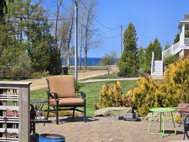 7251 E Beach Dr, South Haven, MI 49090 - view of patio with stairs and a water view