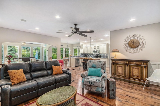 7251 E Beach Dr, South Haven, MI 49090 - living room featuring a ceiling fan, arched walkways, light wood-style flooring, and recessed lighting