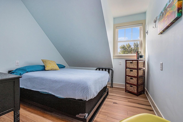 7251 E Beach Dr, South Haven, MI 49090 - bedroom featuring light wood-type flooring and baseboards