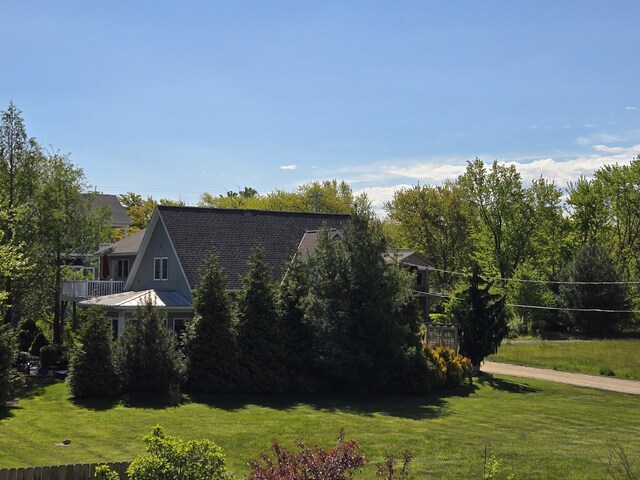 7251 E Beach Dr, South Haven, MI 49090 - view of home's exterior featuring a lawn and a shingled roof