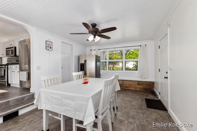8131 Lorac St, Portage, MI 49002 - dining room featuring arched walkways, ceiling fan, baseboards, and ornamental molding