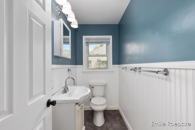 8131 Lorac St, Portage, MI 49002 - half bath with wainscoting, toilet, vanity, and tile patterned floors