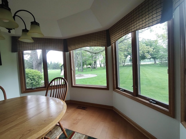 unfurnished dining area with wood finished floors and baseboards