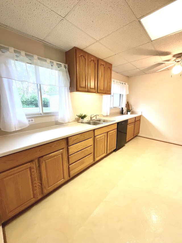 5817 Everest Dr, Clarkston, MI 48346 - kitchen with black dishwasher, a sink, a paneled ceiling, brown cabinetry, and plenty of natural light