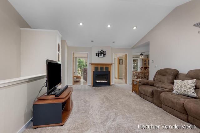 carpeted living area with a ceiling fan, vaulted ceiling, recessed lighting, a fireplace with flush hearth, and baseboards