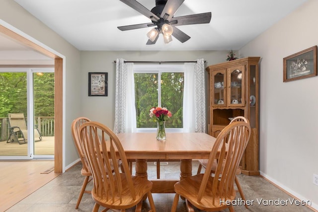 dining space with healthy amount of natural light, a ceiling fan, and baseboards