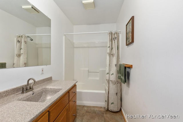 bathroom with vanity, shower / bath combination with curtain, and baseboards
