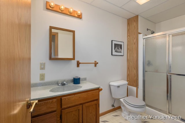 bathroom with a stall shower, vanity, and toilet