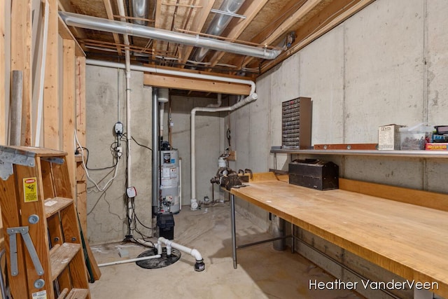 unfinished basement featuring a workshop area and water heater