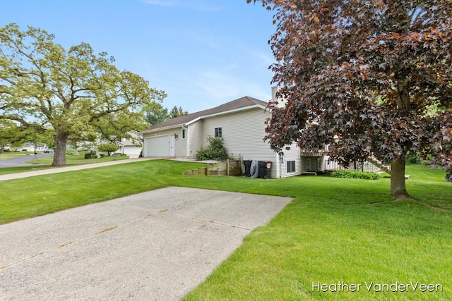 view of property exterior with a garage, a yard, and driveway