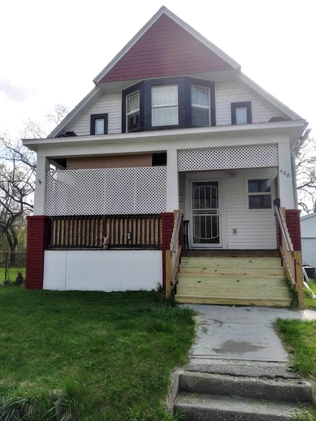508 N Roosevelt Austin Ave, Saginaw, MI 48607 - view of front of property featuring covered porch and a front lawn