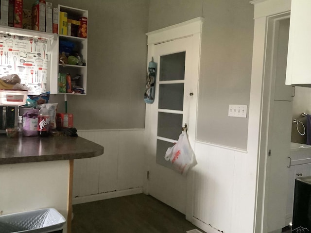 508 N Roosevelt Austin Ave, Saginaw, MI 48607 - kitchen featuring wainscoting, dark countertops, white cabinetry, and a decorative wall