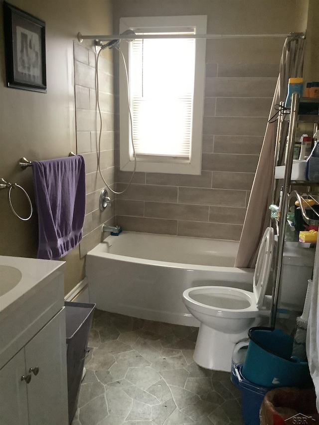 508 N Roosevelt Austin Ave, Saginaw, MI 48607 - bathroom featuring shower / bath combination with curtain, toilet, vanity, and stone finish floors