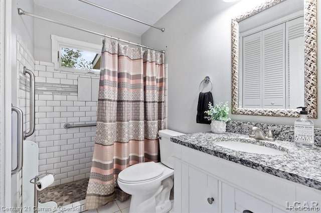 117 Studer Dr, Grass Lake, MI 49240 - full bath with a tile shower, vanity, toilet, vaulted ceiling, and tile patterned flooring