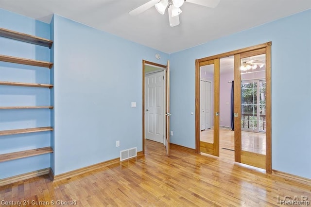 117 Studer Dr, Grass Lake, MI 49240 - unfurnished bedroom featuring light wood finished floors, baseboards, ceiling fan, and french doors