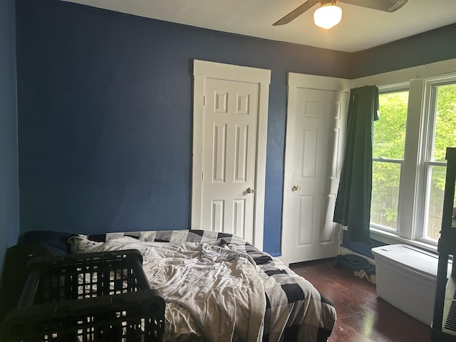 172 Goguac St W, Battle Creek, MI 49015 - bedroom with multiple windows, wood finished floors, and a ceiling fan