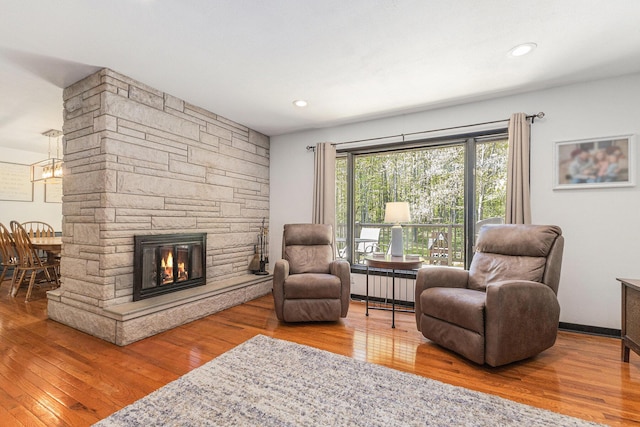 living room with wood finished floors and a fireplace