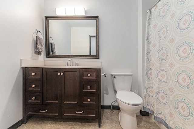 bathroom with baseboards, toilet, vanity, and curtained shower
