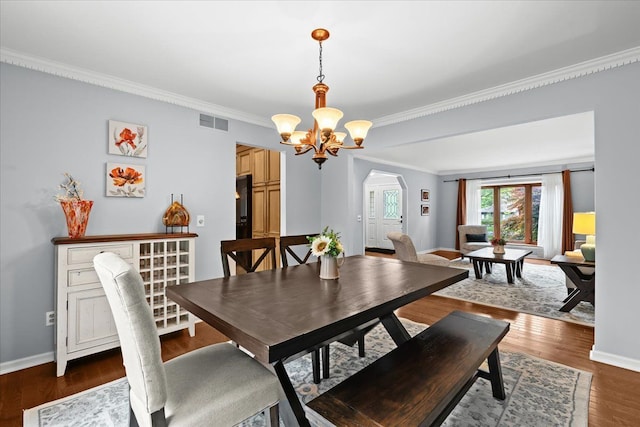 6588 White Pines Dr, Brighton, MI 48116 - dining area featuring a chandelier, ornamental molding, arched walkways, wood finished floors, and baseboards