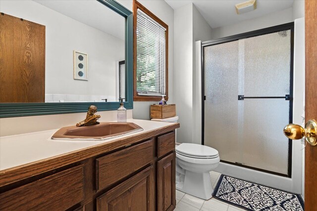 6588 White Pines Dr, Brighton, MI 48116 - full bathroom featuring toilet, tile patterned flooring, a shower stall, and vanity