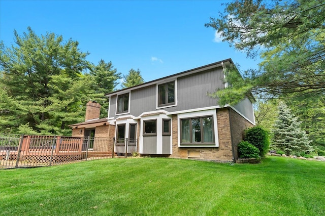 6588 White Pines Dr, Brighton, MI 48116 - rear view of property featuring a yard, a chimney, a deck, and brick siding