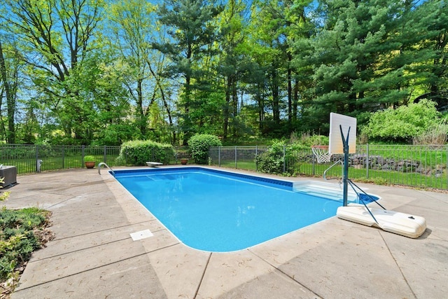 6588 White Pines Dr, Brighton, MI 48116 - view of swimming pool featuring fence, a patio area, and view of wooded area