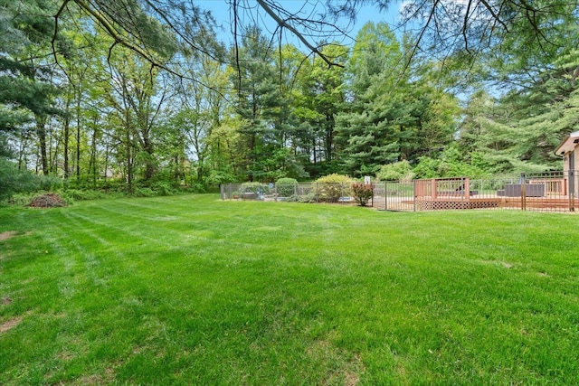 6588 White Pines Dr, Brighton, MI 48116 - view of yard featuring a wooden deck