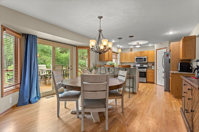 dining area featuring light wood-type flooring, a chandelier, recessed lighting, and baseboards