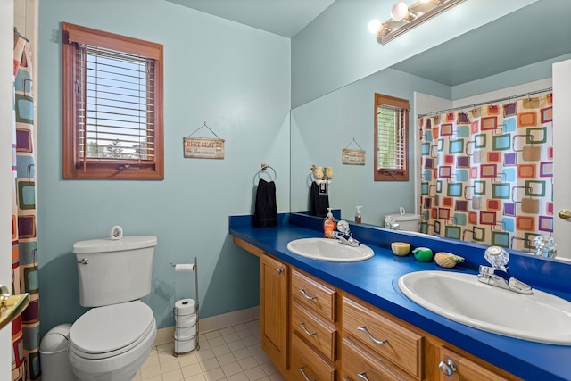 bathroom with toilet, tile patterned flooring, double vanity, baseboards, and a shower with shower curtain