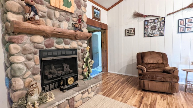 7884 N Saint Helen Rd, Saint Helen, MI 48656 - living area with wood finished floors, baseboards, wooden walls, a stone fireplace, and vaulted ceiling