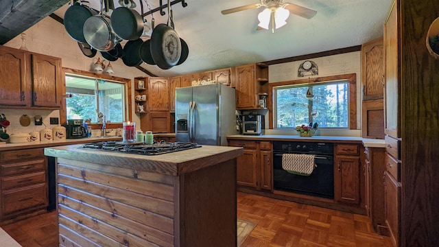 7884 N Saint Helen Rd, Saint Helen, MI 48656 - kitchen with black appliances, open shelves, light countertops, and a kitchen island
