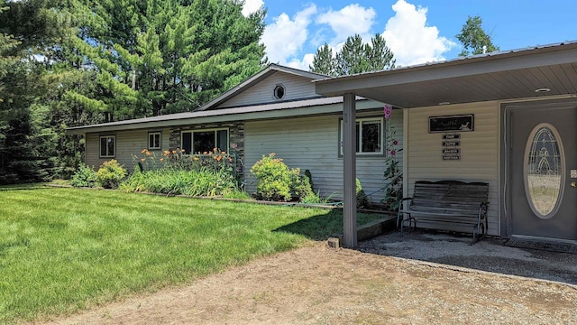 7884 N Saint Helen Rd, Saint Helen, MI 48656 - ranch-style home with a front lawn and an attached carport