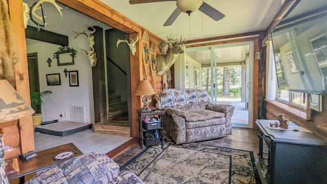 7884 N Saint Helen Rd, Saint Helen, MI 48656 - living room featuring a ceiling fan, stairs, and tile patterned flooring