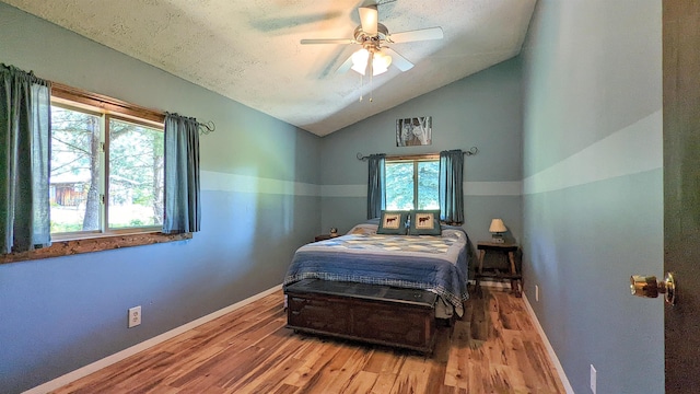 7884 N Saint Helen Rd, Saint Helen, MI 48656 - bedroom featuring wood finished floors, baseboards, lofted ceiling, and ceiling fan