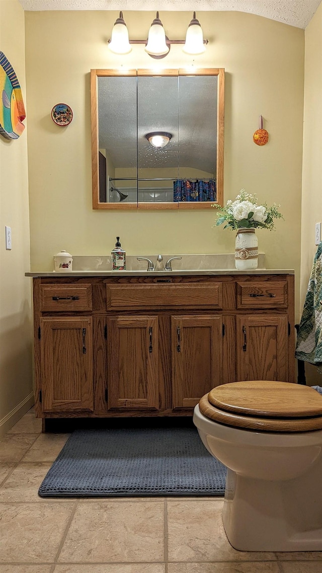 7884 N Saint Helen Rd, Saint Helen, MI 48656 - bathroom featuring vanity, toilet, a textured ceiling, and baseboards