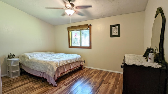 7884 N Saint Helen Rd, Saint Helen, MI 48656 - bedroom with wood finished floors, baseboards, and ceiling fan