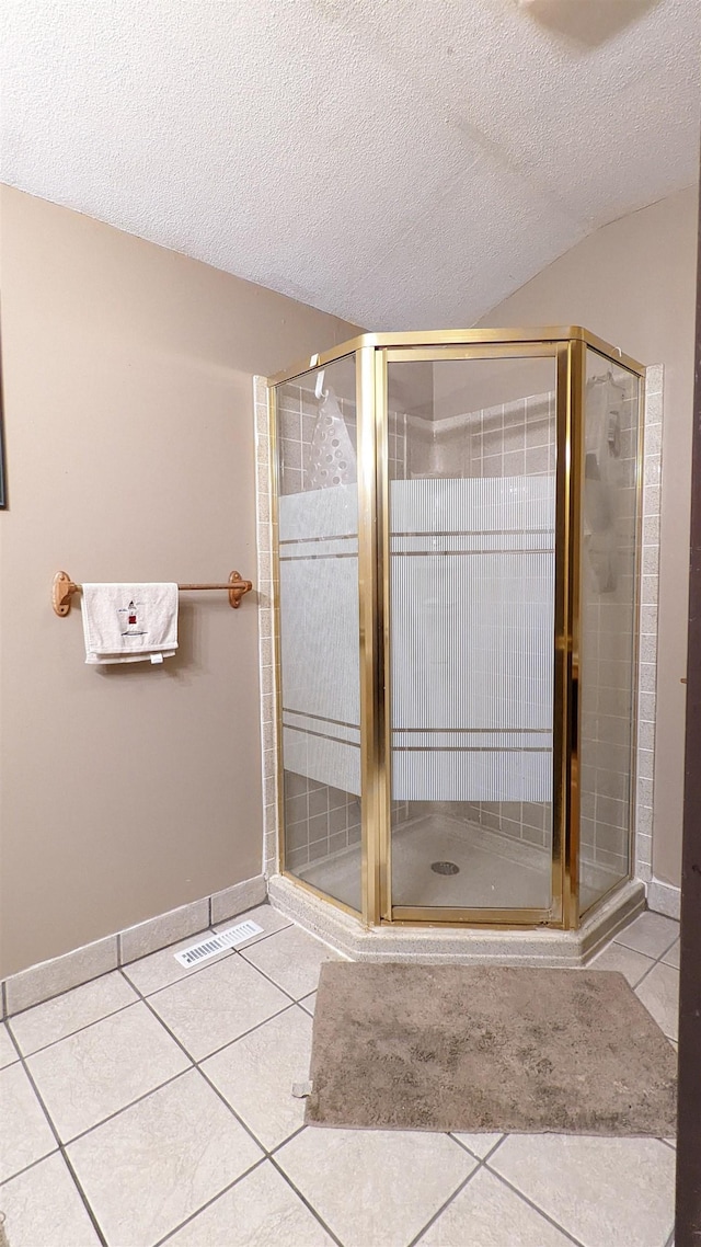 7884 N Saint Helen Rd, Saint Helen, MI 48656 - full bath with tile patterned floors, a textured ceiling, a stall shower, and baseboards