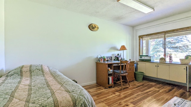 7884 N Saint Helen Rd, Saint Helen, MI 48656 - office area featuring wood finished floors, a textured ceiling, and baseboards