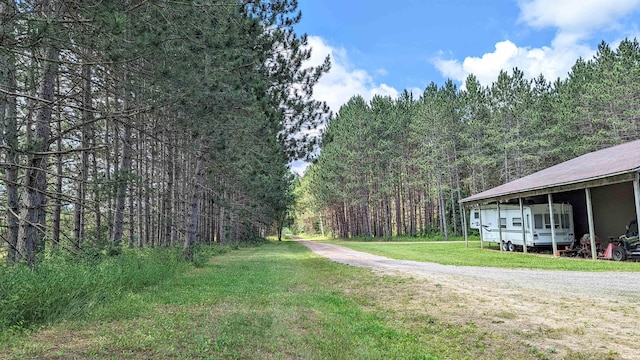 7884 N Saint Helen Rd, Saint Helen, MI 48656 - view of grassy yard featuring a forest view and driveway