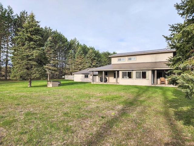 7884 N Saint Helen Rd, Saint Helen, MI 48656 - back of property featuring a yard and metal roof