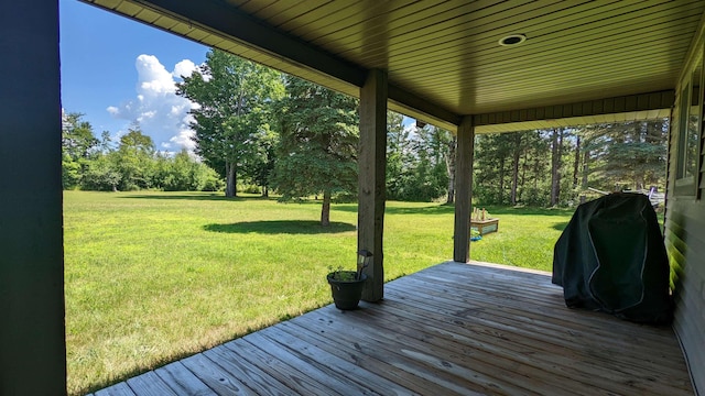 7884 N Saint Helen Rd, Saint Helen, MI 48656 - wooden deck with a lawn, view of scattered trees, and grilling area