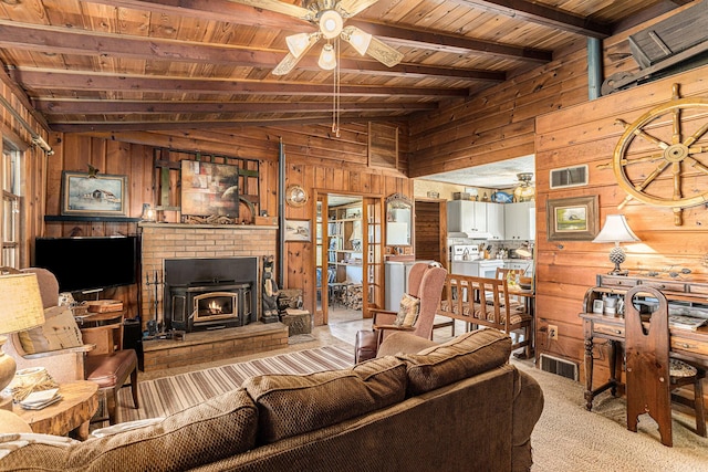 6520 Oakwood Dr, Delton, MI 49046 - living area with wood walls, wooden ceiling, a ceiling fan, and carpet