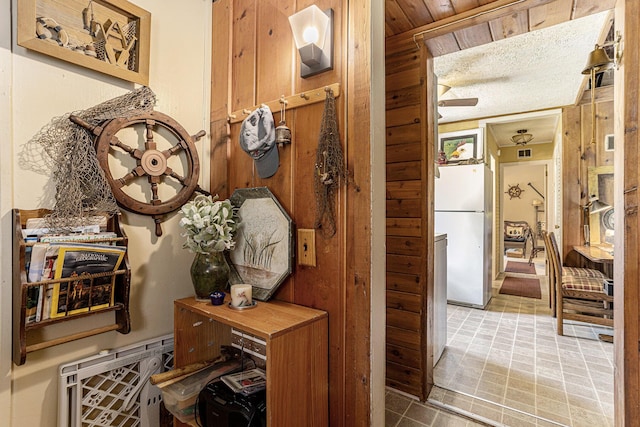 6520 Oakwood Dr, Delton, MI 49046 - corridor featuring wood walls and tile patterned floors