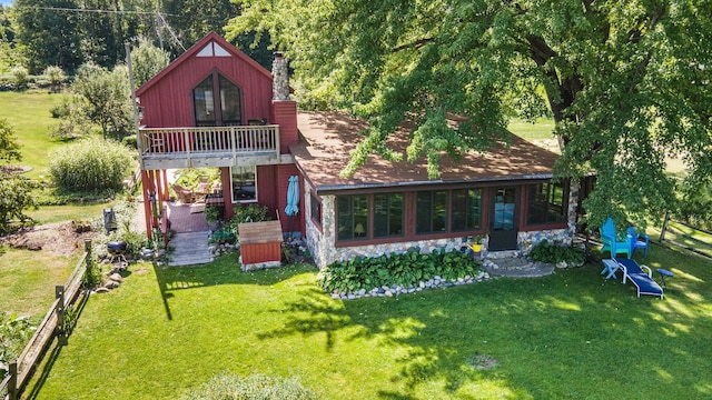6520 Oakwood Dr, Delton, MI 49046 - rear view of property featuring stone siding, a lawn, and a chimney