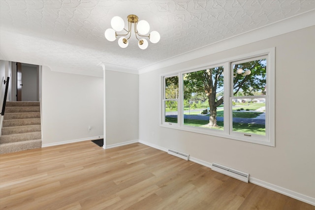5082 Patland Dr, Kalamazoo, MI 49009 - unfurnished room with stairs, light wood-style floors, a chandelier, baseboards, and an ornate ceiling