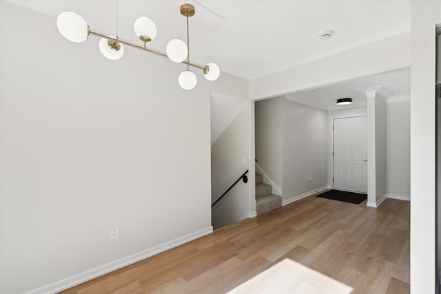 5082 Patland Dr, Kalamazoo, MI 49009 - entrance foyer with light wood-type flooring, stairway, and baseboards